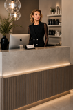 Salon professional wearing the BLACKPANTS Boston Vest at reception, showcasing the tailored silhouette and double-breasted button detailing