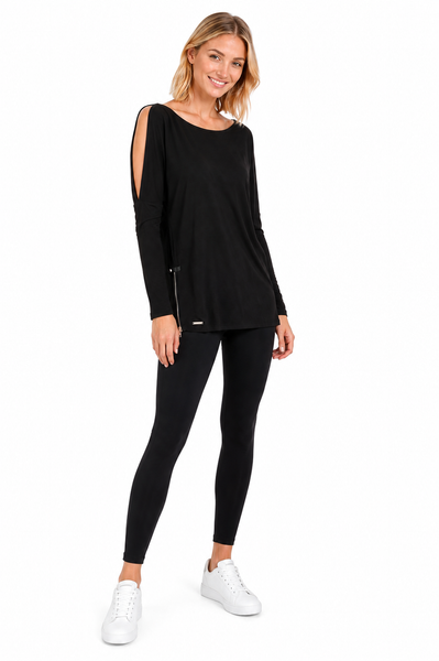 Full-length view of model wearing the BLACKPANTS Open Shoulder Drape Top in black styled with black leggings and white sneakers